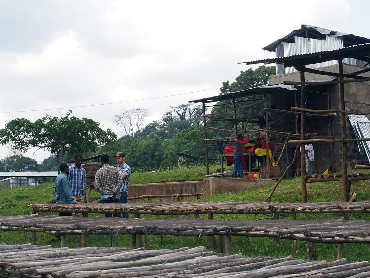 The managers of the Duromina Cooperative (Ethiopia) and Reuben discussing the latest changes to the mill station #2 in 2017