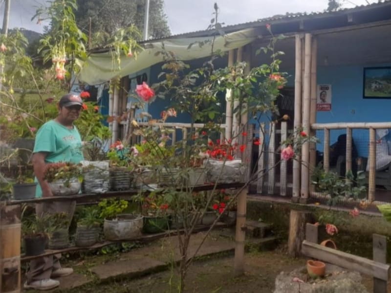 Javier Quintero’s posing before his house.